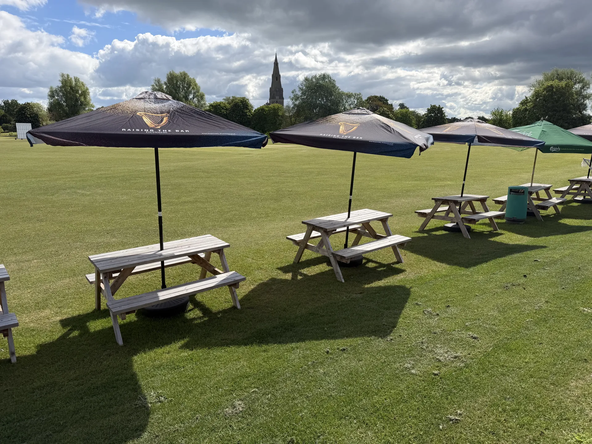 Beer garden tables looking out over the field to the church