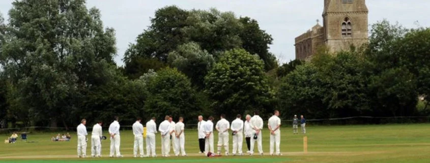Cricketers lining up in front of the church