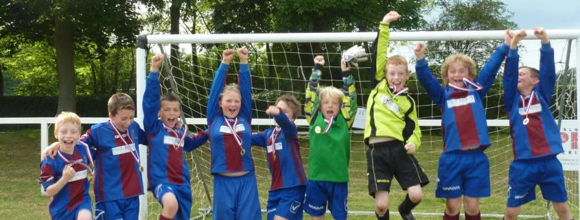 Cheering junior footballers