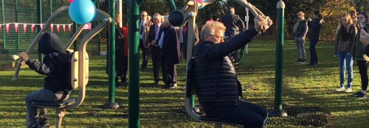 Young and old people using the gym equipment